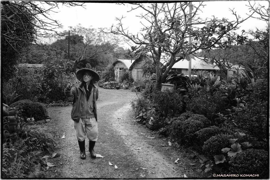 Awamori hermit Seibin Shimabukuro in the garden